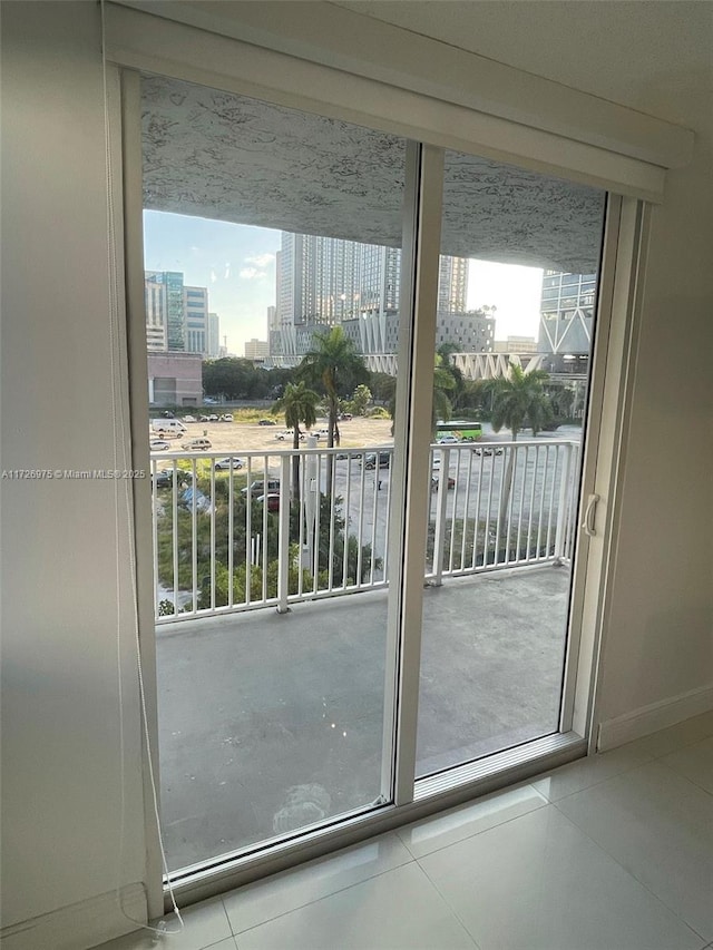 entryway with a view of city and tile patterned floors