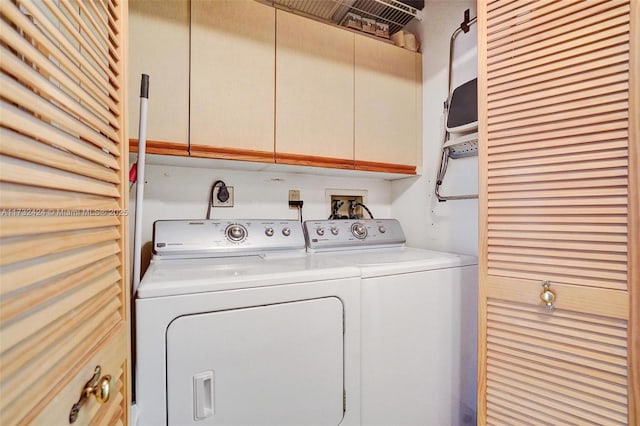 washroom with cabinets and separate washer and dryer