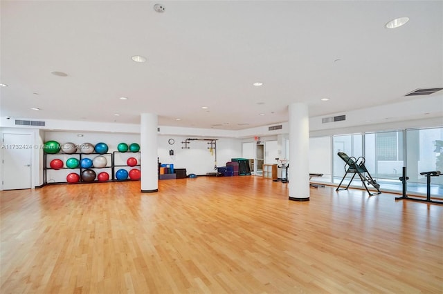 exercise room with light wood-type flooring