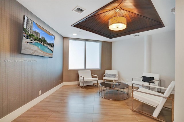 living area featuring a tray ceiling