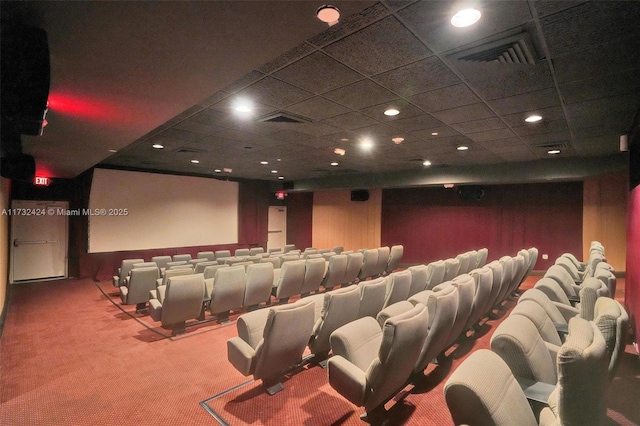 home theater room featuring a drop ceiling and carpet