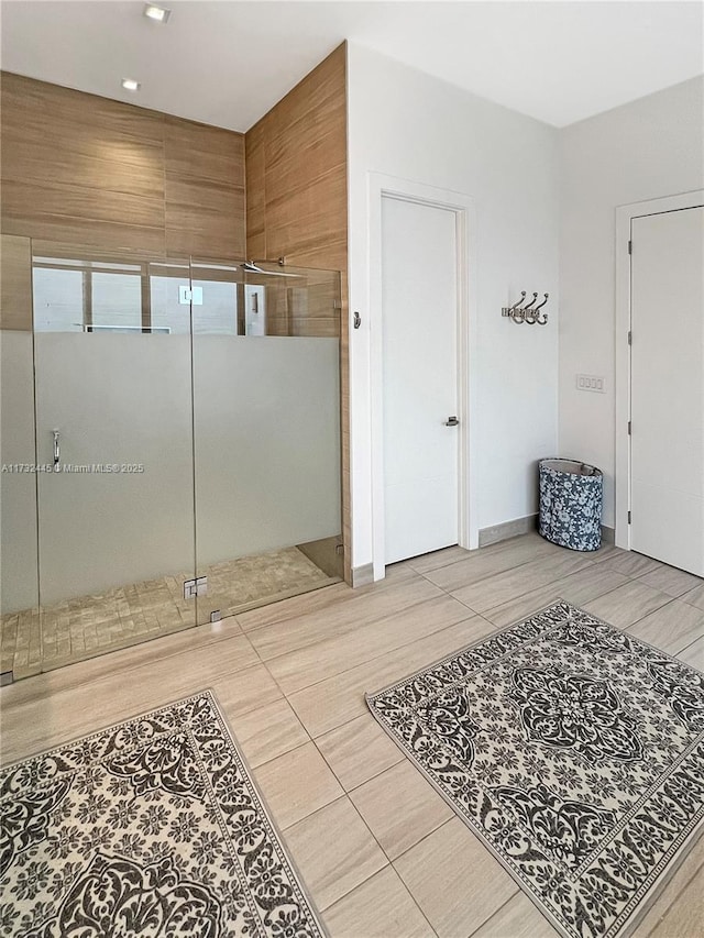 bathroom with tile patterned flooring and a shower with door