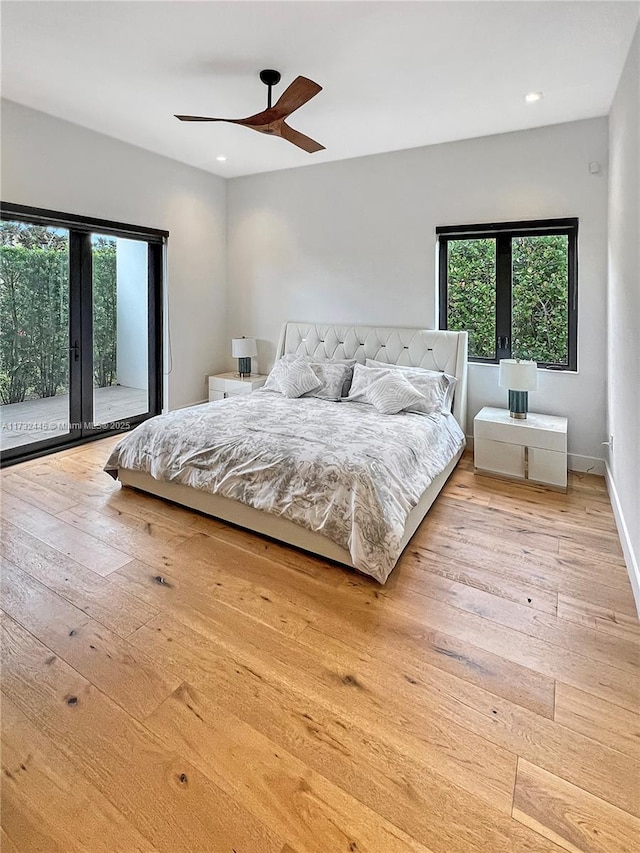 bedroom with multiple windows, ceiling fan, light hardwood / wood-style flooring, and access to outside