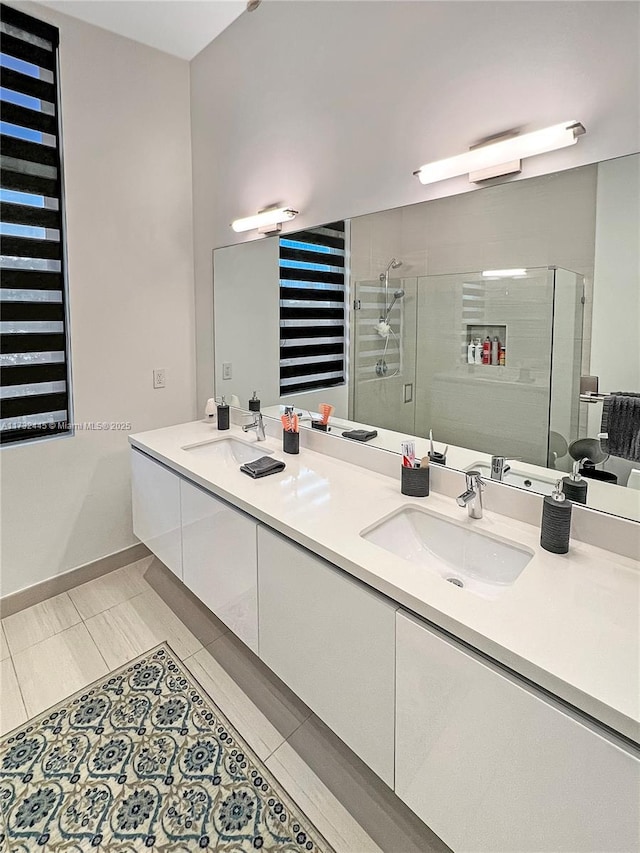 bathroom with tile patterned floors, an enclosed shower, and vanity