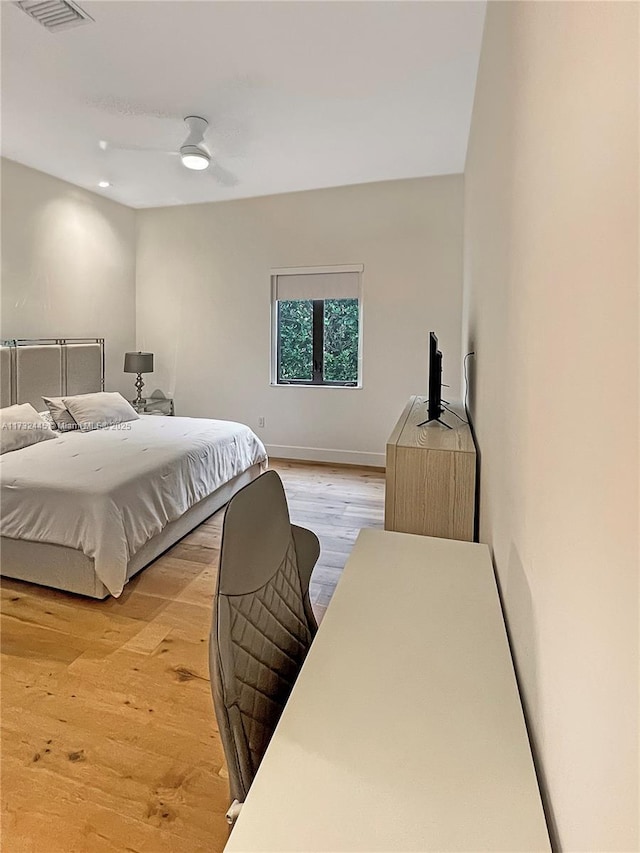 bedroom featuring light hardwood / wood-style flooring and ceiling fan