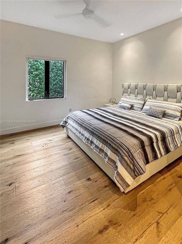 bedroom with hardwood / wood-style floors and ceiling fan