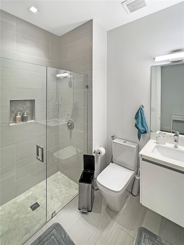 bathroom with walk in shower, vanity, and toilet