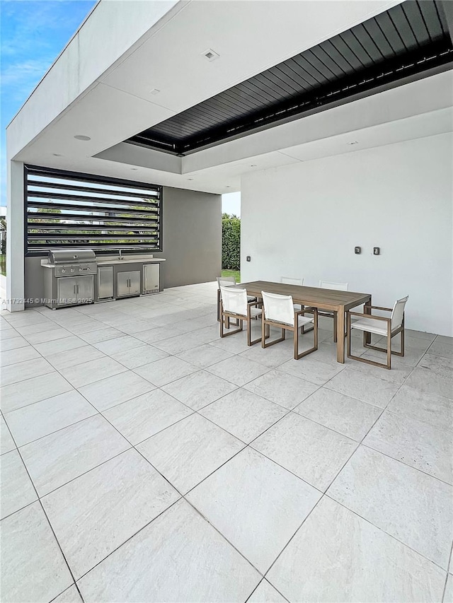 view of patio / terrace featuring area for grilling and a grill