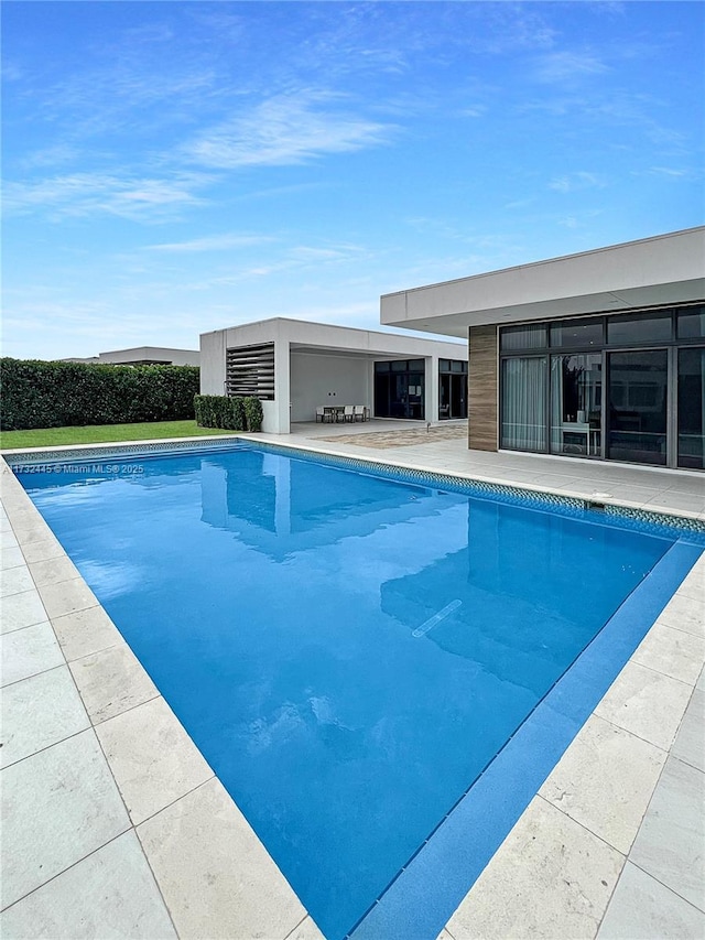 view of swimming pool with a patio