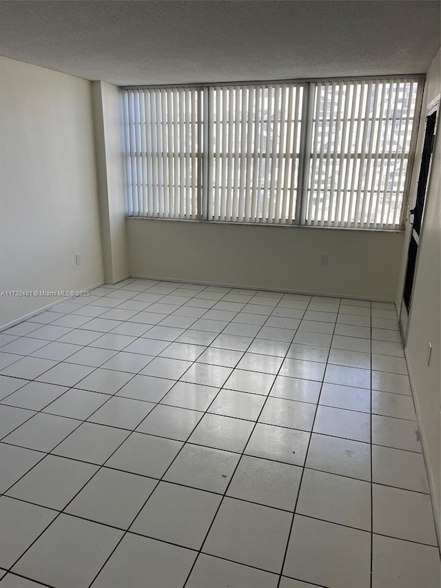 tiled empty room with a healthy amount of sunlight