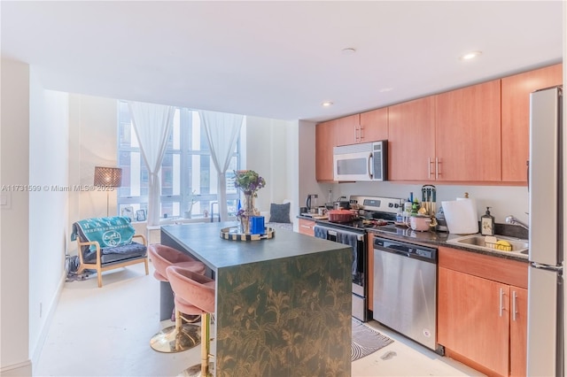 kitchen featuring sink, a kitchen island, and appliances with stainless steel finishes