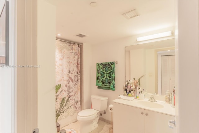 bathroom with vanity, tile patterned flooring, and toilet