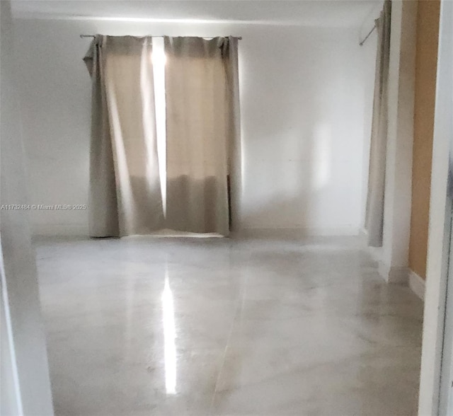 spare room with concrete flooring