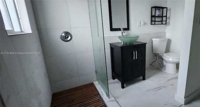 bathroom with vanity, a shower, and toilet