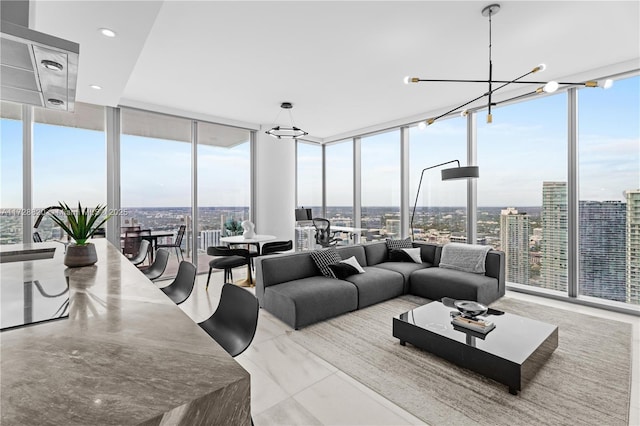 living room with a wall of windows and a notable chandelier