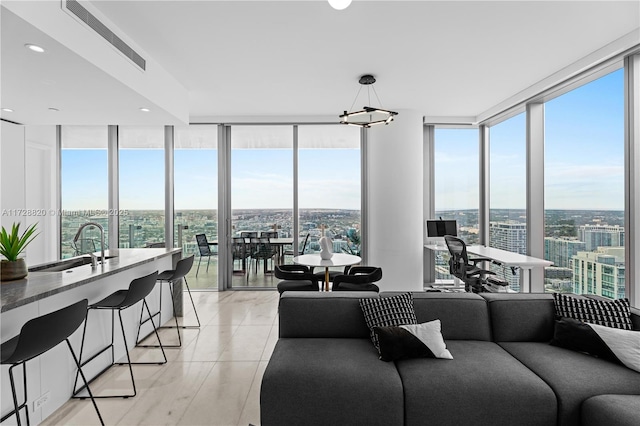 living room featuring floor to ceiling windows, sink, and light tile patterned floors