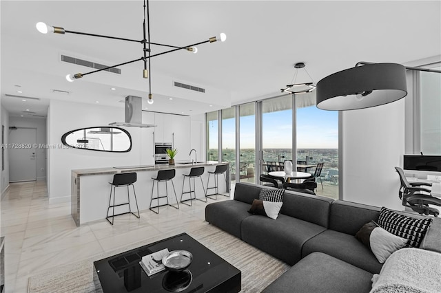 living room with expansive windows and sink