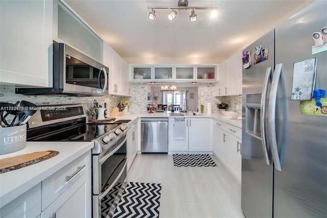 kitchen featuring white cabinetry and appliances with stainless steel finishes