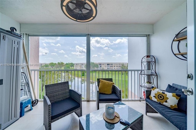 sunroom featuring a water view and a wealth of natural light