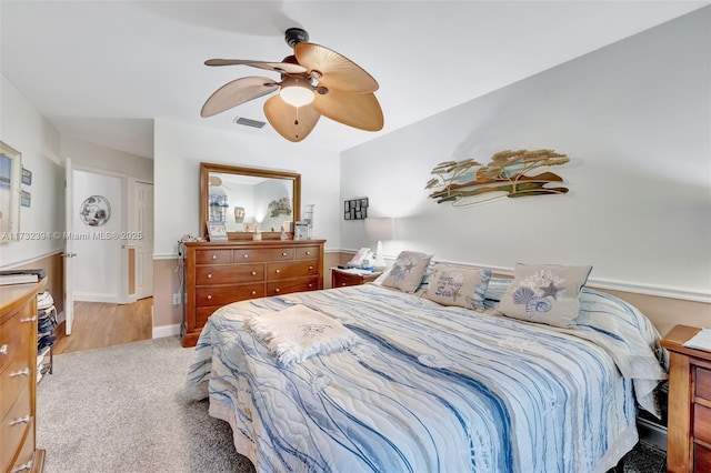 carpeted bedroom with ceiling fan and a closet