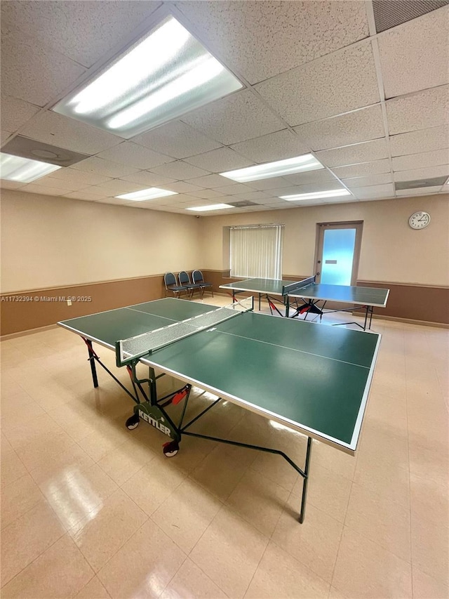 recreation room with a paneled ceiling