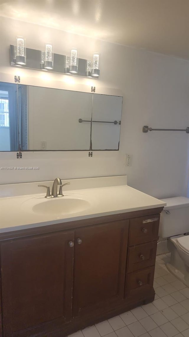 bathroom featuring tile patterned floors, toilet, and vanity