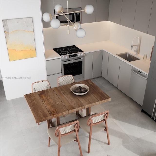 kitchen featuring stainless steel appliances, sink, and gray cabinetry