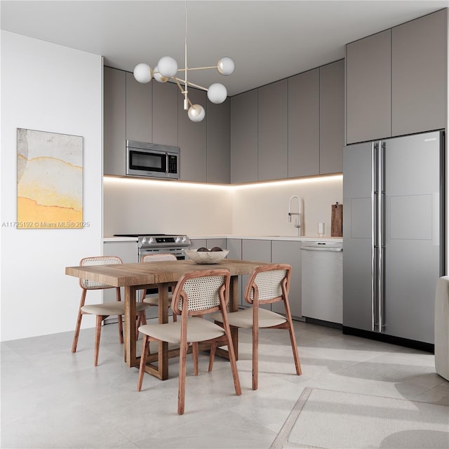 kitchen featuring paneled fridge, sink, gray cabinetry, and white dishwasher