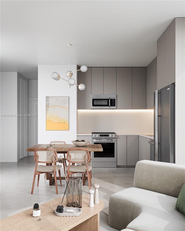 kitchen with gray cabinets and appliances with stainless steel finishes