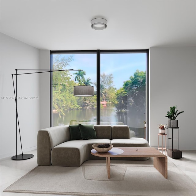 living room featuring expansive windows, a water view, and a wealth of natural light