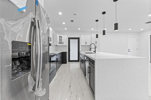 2814 SW 92nd Ct, Miami, FL 33165 - kitchen featuring sink, white cabinetry, stainless steel fridge, a kitchen island, and pendant lighting