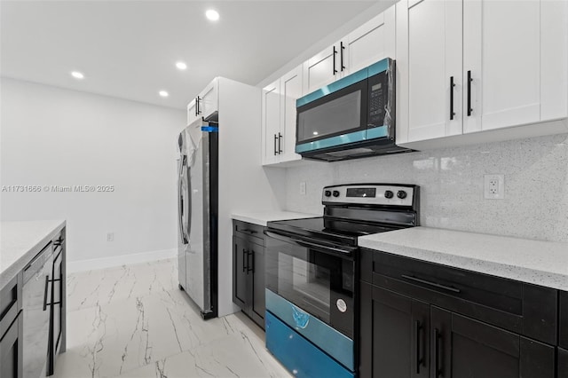 2814 SW 92nd Ct, Miami, FL 33165 - kitchen featuring a barn door, white cabinetry, appliances with stainless steel finishes, and decorative backsplash