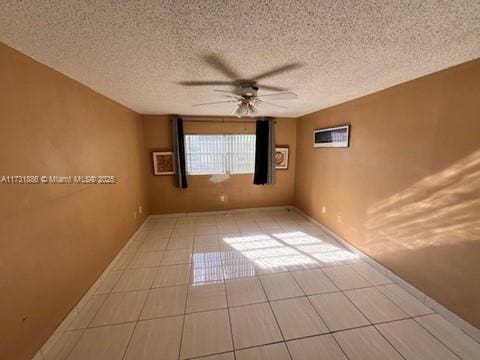 unfurnished room featuring light tile patterned floors and ceiling fan