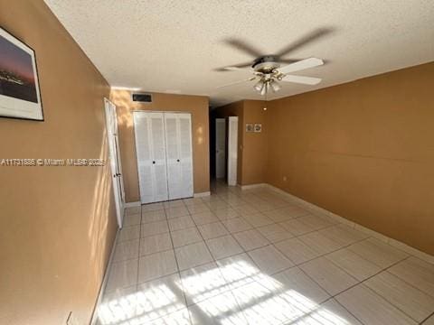 unfurnished bedroom with a textured ceiling and ceiling fan