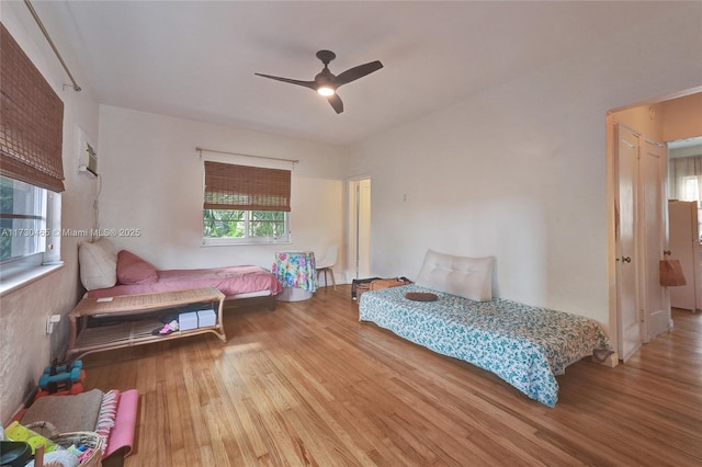 bedroom with hardwood / wood-style flooring and ceiling fan