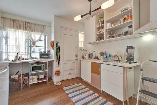 kitchen with white cabinetry, plenty of natural light, and dark hardwood / wood-style flooring