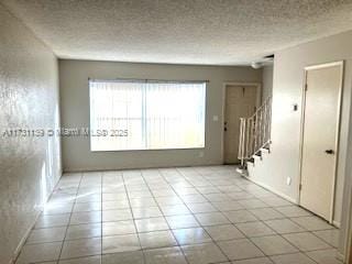 spare room featuring a healthy amount of sunlight and a textured ceiling