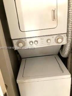 laundry room with stacked washer / dryer