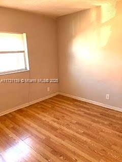 empty room featuring hardwood / wood-style flooring