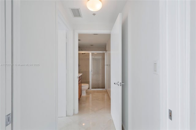 corridor featuring light tile patterned floors