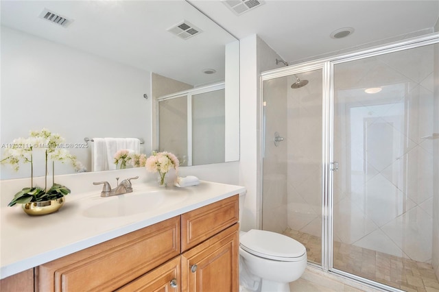 bathroom featuring vanity, a shower with shower door, and toilet