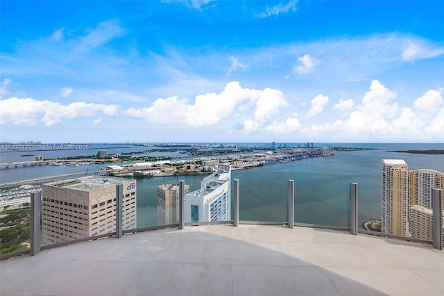 view of patio featuring a water view and a city view