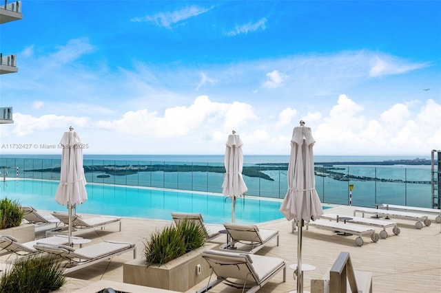 view of swimming pool with a water view