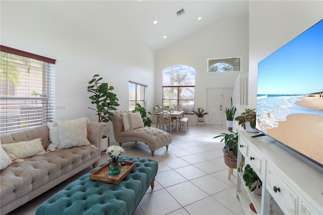 tiled living room featuring high vaulted ceiling