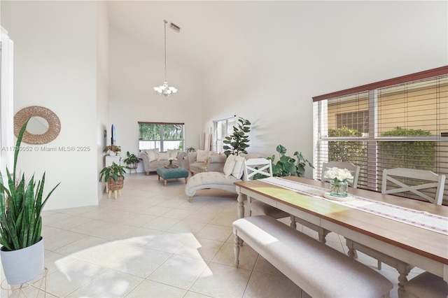 dining area with a chandelier, high vaulted ceiling, and light tile patterned floors