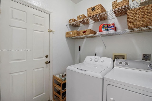 clothes washing area with washing machine and clothes dryer