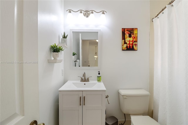 bathroom featuring vanity and toilet