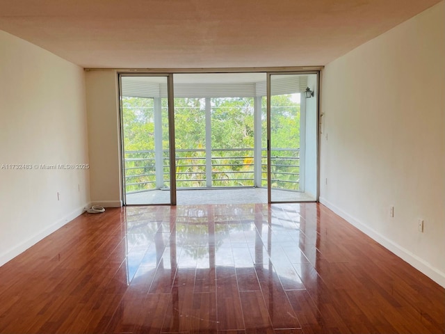 empty room featuring hardwood / wood-style floors and floor to ceiling windows