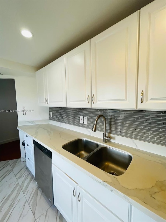 kitchen with white cabinetry, sink, and dishwasher