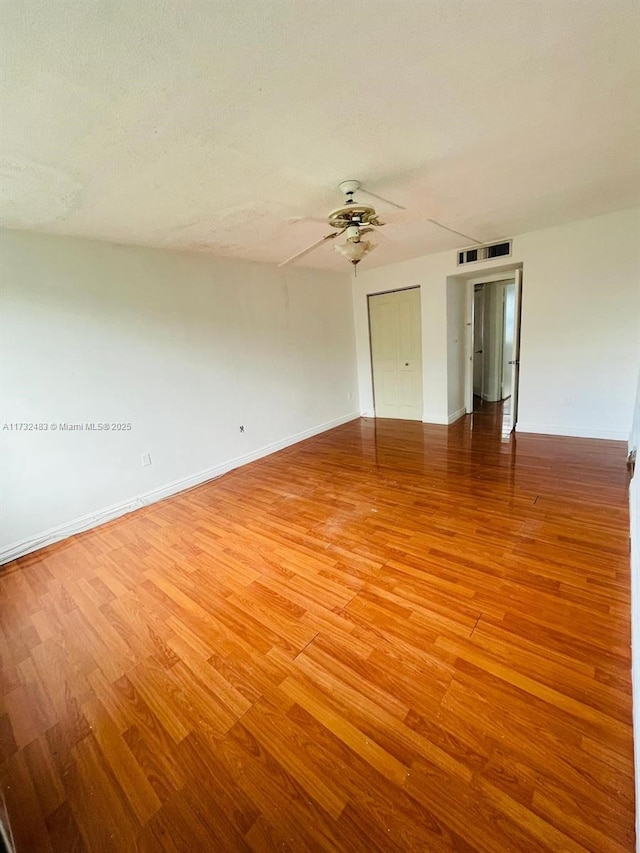 unfurnished room with hardwood / wood-style flooring and ceiling fan